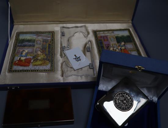 A pair of Indian painted marble plaques (cased with stands), a faux tortoiseshell vanity/cigarette case and a plated cigarette case